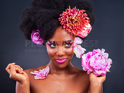 Buy stock photo African, girl and beauty with flowers, happy and confidence for makeup, skincare and wellness in studio. Female person, pose and smile for fashion, style and luxury in grey background for cosmetics