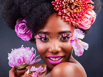 Buy stock photo Studio shot of a beautiful young woman posing with flowers in her hair