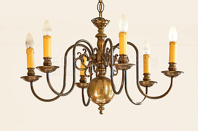 Buy stock photo Classy vintage hanging lights for a grand foyer or dinning room. Golden candle like lighting object for a royal Victorian interior style design. Brass chandelier hanging with many light bulbs.