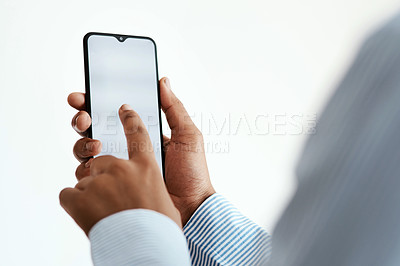 Buy stock photo Cropped studio sot of an unrecognisable businesswoman using a smartphone against a white background