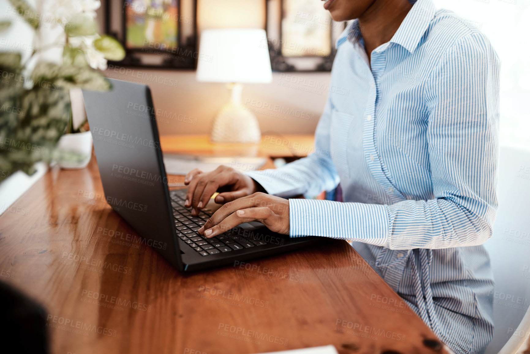 Buy stock photo Cropped shot of a businesswoman using a laptop at her desk