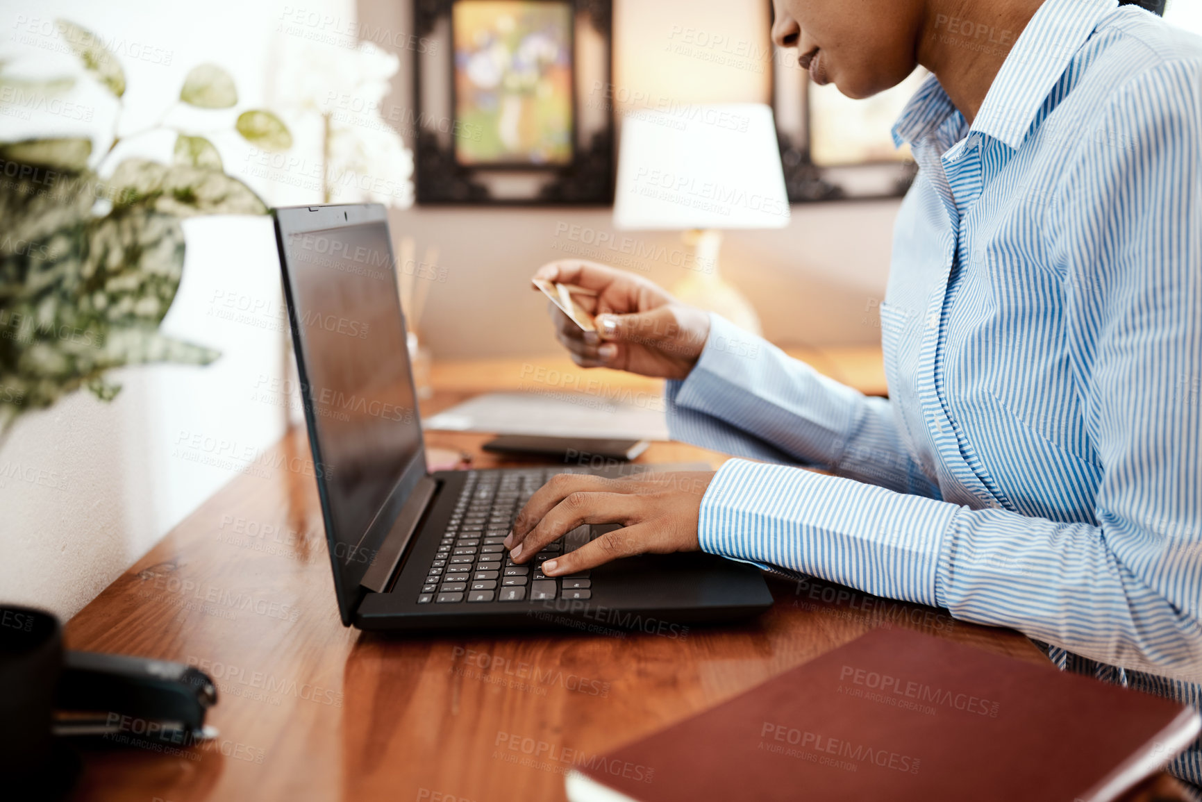 Buy stock photo Cropped shot of a businesswoman using a laptop and credit card