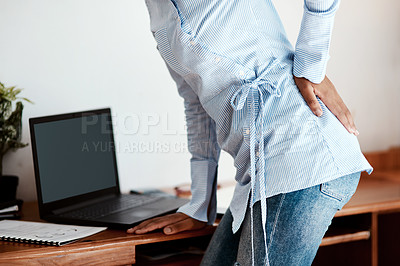 Buy stock photo Cropped shot of a businesswoman experiencing back pain at work