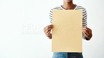 Buy stock photo Cropped studio shot of a woman holding a yellow poster against a white background