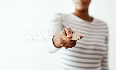 Buy stock photo Cropped studio shot of an unrecognizable woman holding a credit card