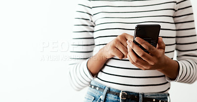 Buy stock photo Cropped shot of a woman using a smartphone against a white studio background