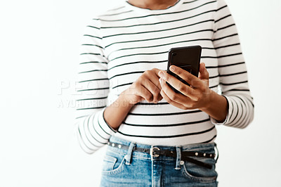 Buy stock photo Cropped shot of a woman using a smartphone against a white studio background