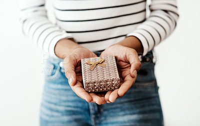 Buy stock photo Cropped shot of a woman holding a gift box against a studio background