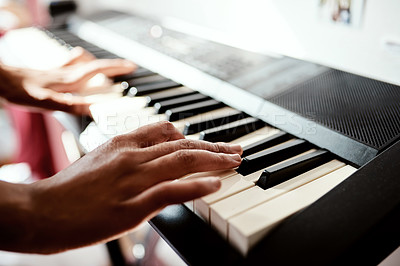 Buy stock photo Cropped shot of a woman playing music on a keyboard at home