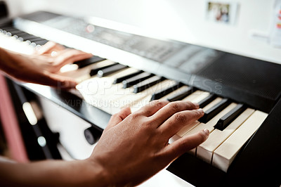 Buy stock photo Cropped shot of a woman playing music on a keyboard at home