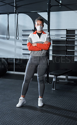 Buy stock photo Portrait of a young woman wearing a face mask in a gym