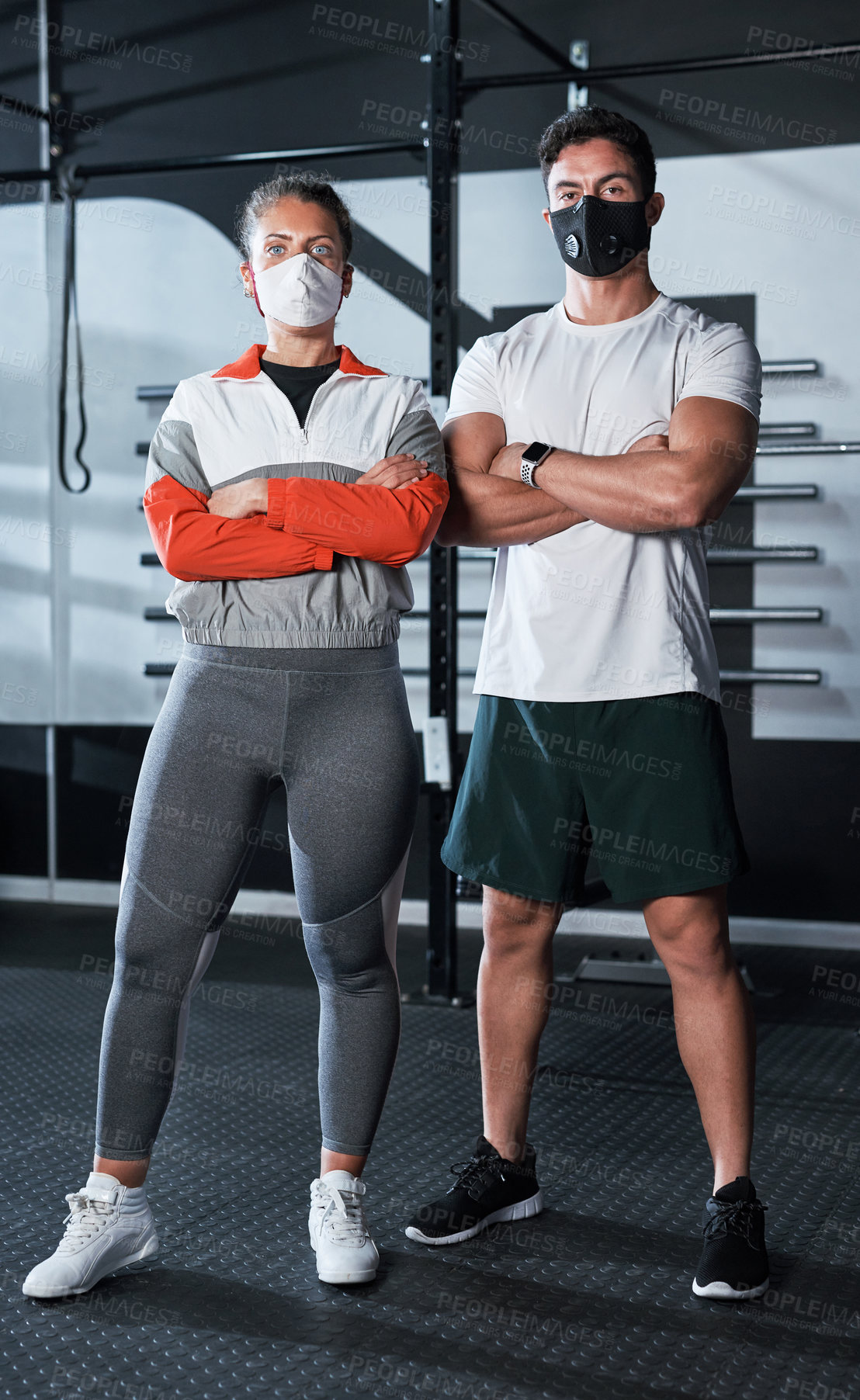 Buy stock photo Portrait of two sporty young people wearing face masks in a gym