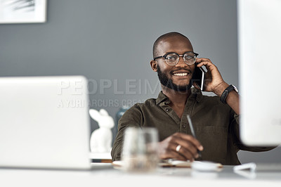 Buy stock photo Shot of a young businessman using a smartphone and computer in a modern office