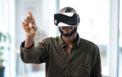 Buy stock photo Shot of a young businessman using a virtual reality headset in a modern office