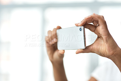 Buy stock photo Cropped shot of an unrecognisable woman photographing the interior of a house with a smartphone
