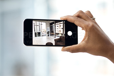 Buy stock photo Cropped shot of an unrecognisable woman photographing the interior of a house with a smartphone