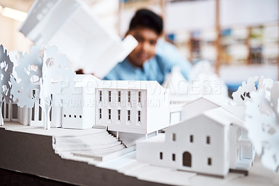 Buy stock photo Shot of an architect designing a building model in a modern office