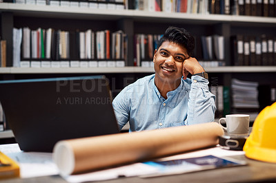 Buy stock photo Portrait of a young architect working at his desk in a modern office