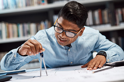 Buy stock photo Shot of a young architect using a compass to draw a building plan
