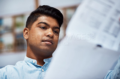 Buy stock photo Shot of a young architect designing a building plan in a modern office