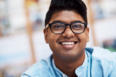 Buy stock photo Portrait of a confident young businessman working in a modern office