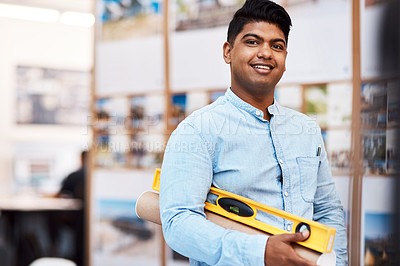 Buy stock photo Portrait of a young man holding a spirit level in a modern office