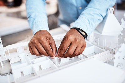 Buy stock photo Shot of an unrecognisable architect designing a building model in a modern office