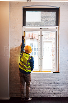 Buy stock photo Shot of a engineer taking measurements on a construction site