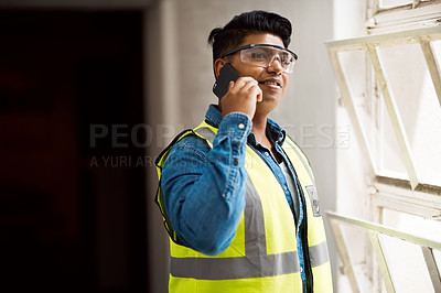 Buy stock photo Cropped shot of a engineer talking on his cellphone while on a construction site