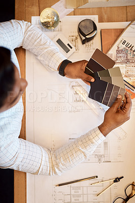 Buy stock photo Shot of an architect deciding on a colour scheme while working on a project