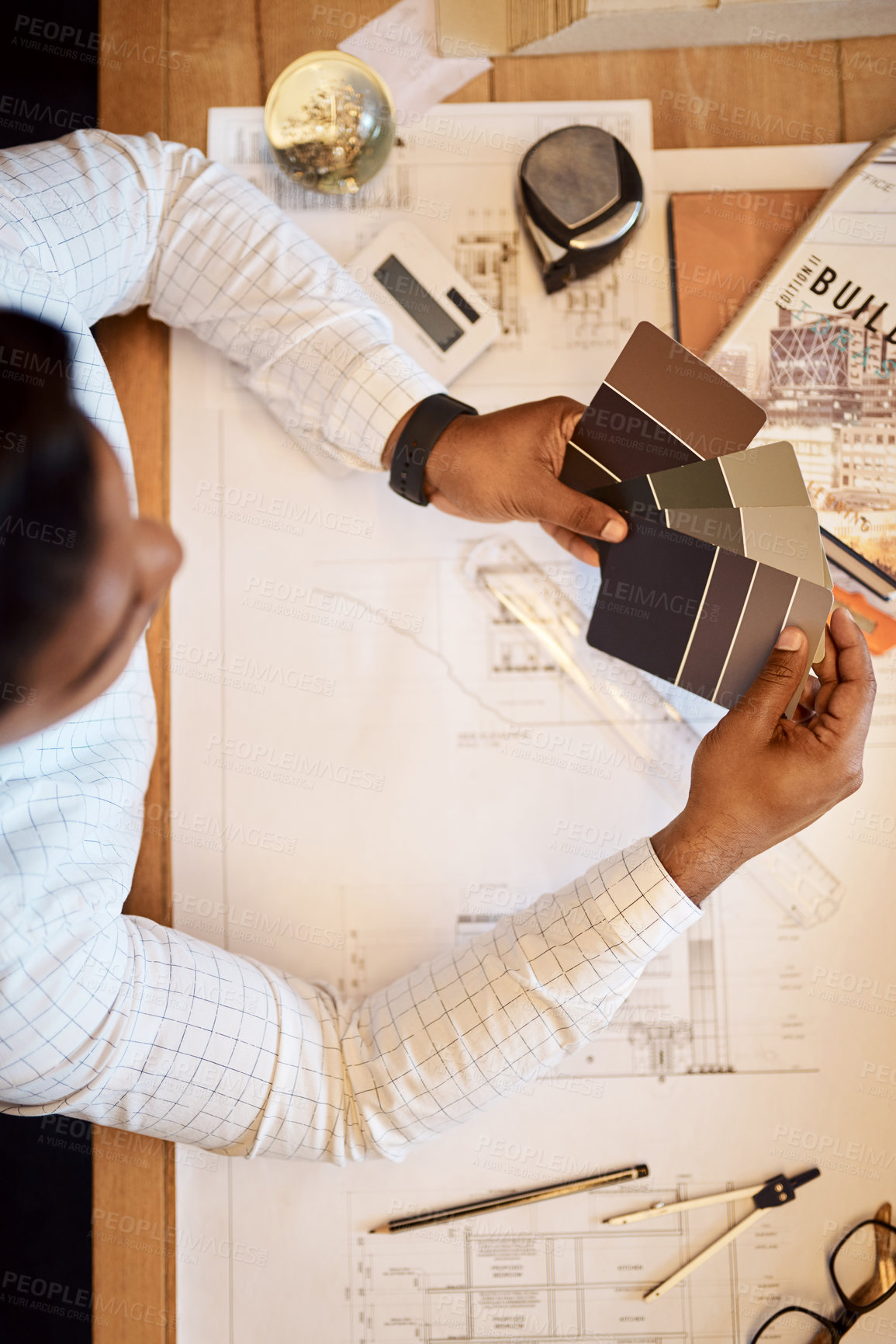 Buy stock photo Shot of an architect deciding on a colour scheme while working on a project