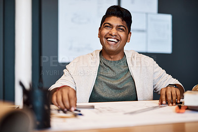 Buy stock photo Shot of a young architect designing a building plan in a modern office