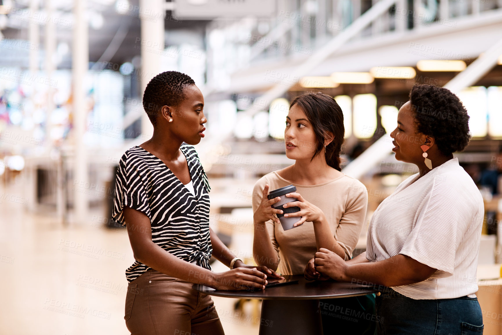 Buy stock photo Shot of a group of young creatives having a discussion in an office