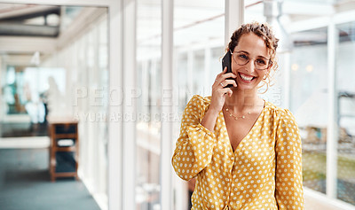 Buy stock photo Cropped shot of an attractive young female designer making a phonecall while standing in her office