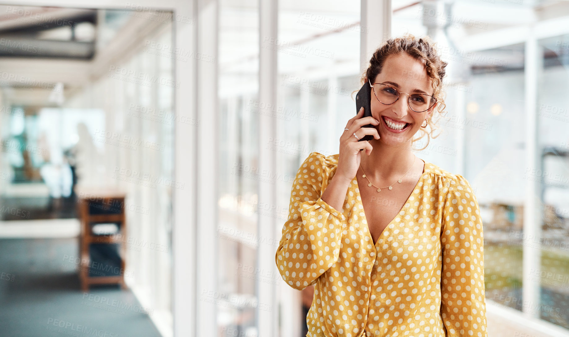 Buy stock photo Cropped shot of an attractive young female designer making a phonecall while standing in her office