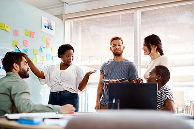 Buy stock photo Shot of a group of young creatives brainstorming together in an office