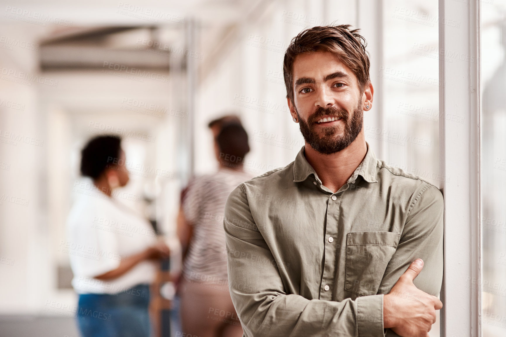 Buy stock photo Portrait of a confident young businessman standing in an office