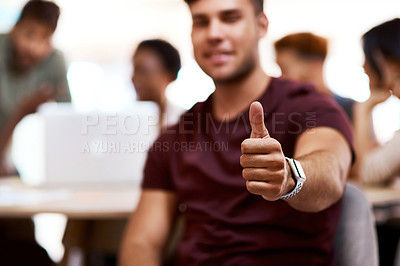 Buy stock photo Closeup shot of a young businessman showing thumbs up in an office