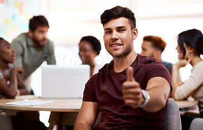 Buy stock photo Portrait of a young businessman showing thumbs up in an office