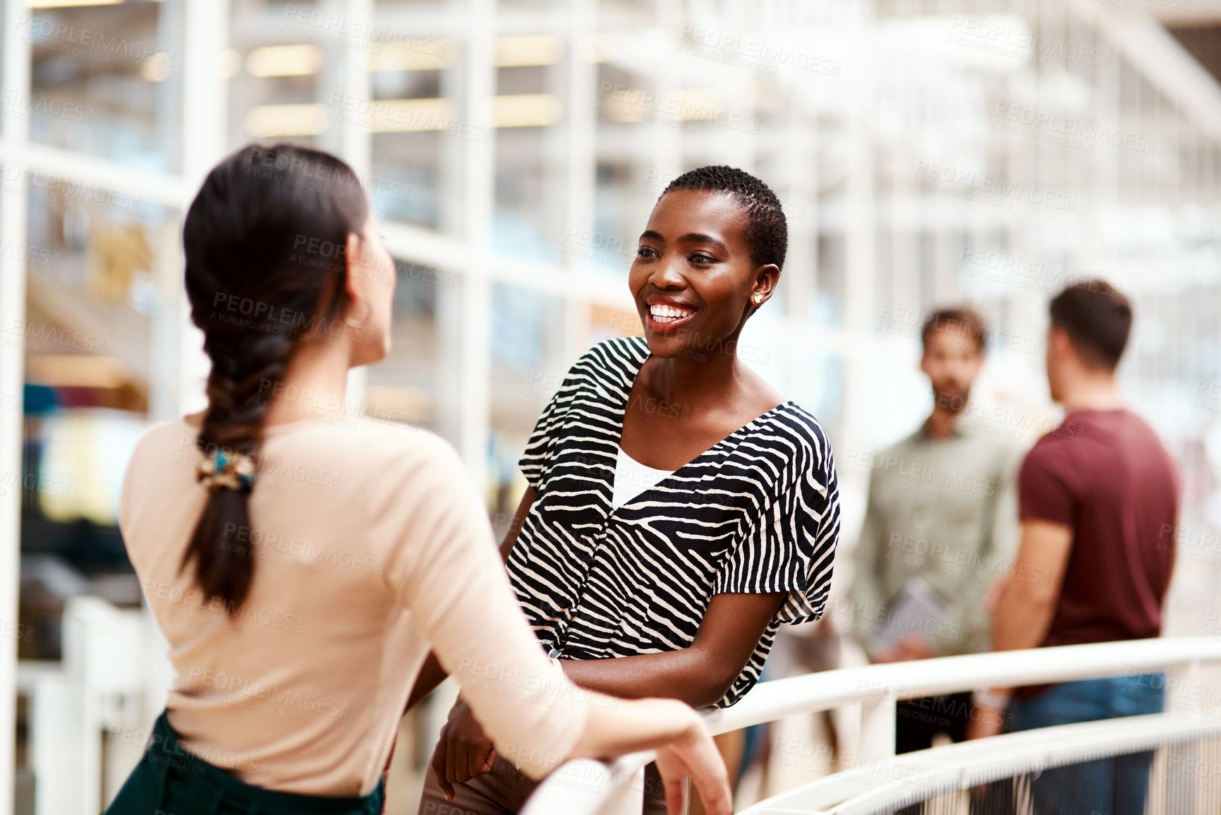 Buy stock photo Shot of a young businesswoman having a discussion with a colleague in an office