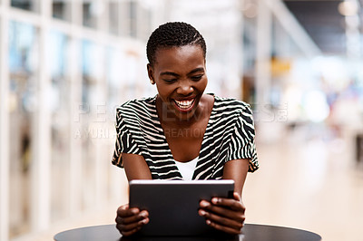 Buy stock photo Shot of a young businesswoman using a digital tablet in an office