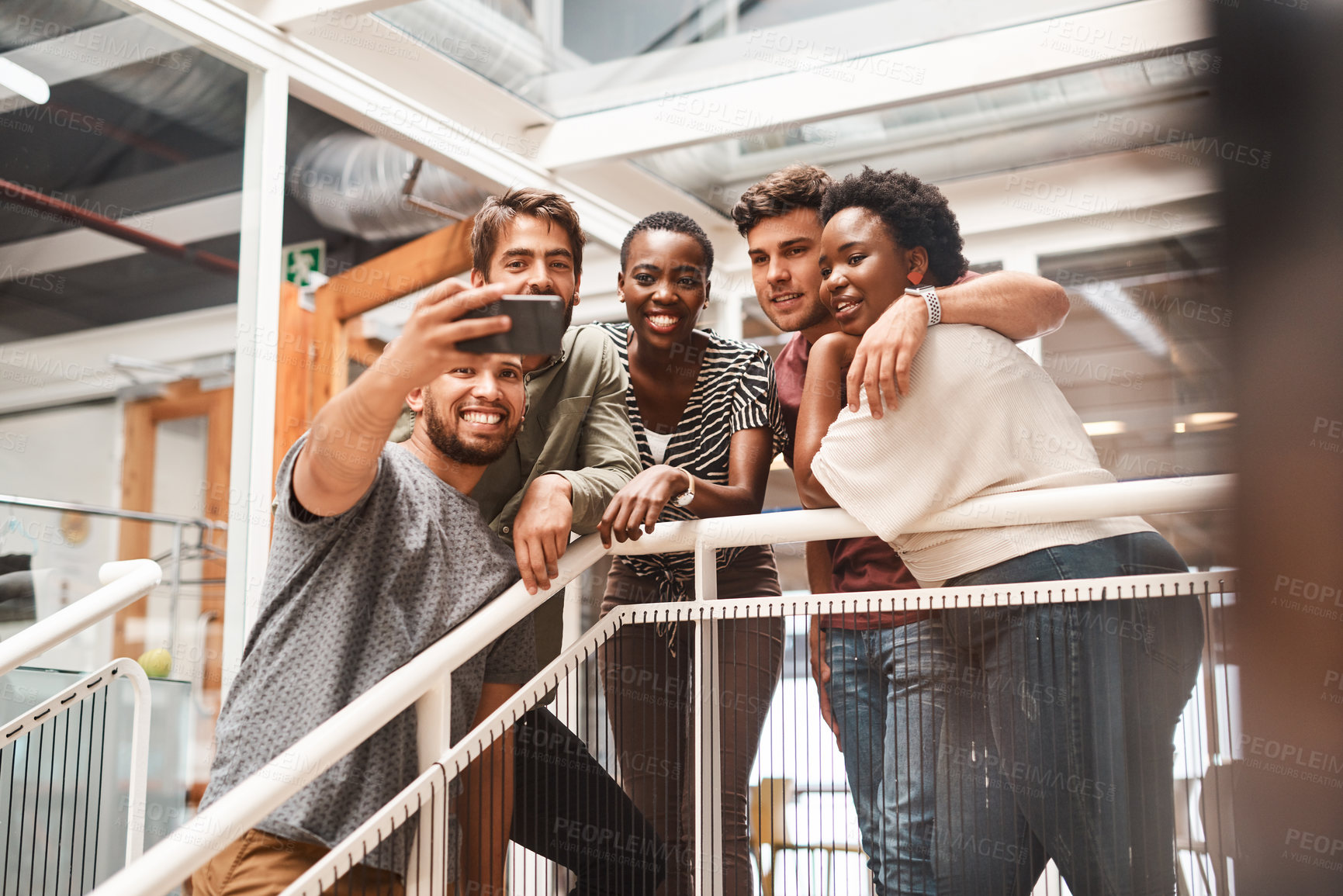 Buy stock photo Shot of a group of young creatives taking selfies together in an office