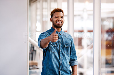 Buy stock photo Cropped portrait of a handsome young male designer giving thumbs up to the camera while standing in his office