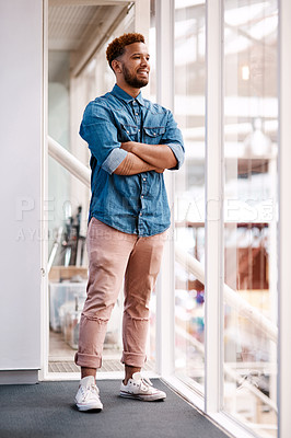 Buy stock photo Full length shot of a handsome young male designer looking thoughtful while standing with his arms crossed in the office