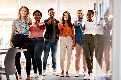 Buy stock photo Full length portrait of a group of young designers giving thumbs up to the camera while standing in the boardroom of their office