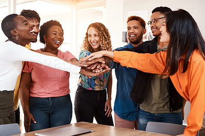 Buy stock photo Cropped shot of a group of young designers standing with their hands in a huddle in the office