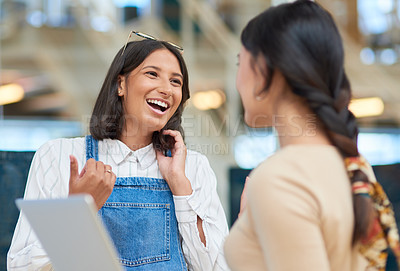 Buy stock photo Shot of a young businesswoman talking to a colleague in an office