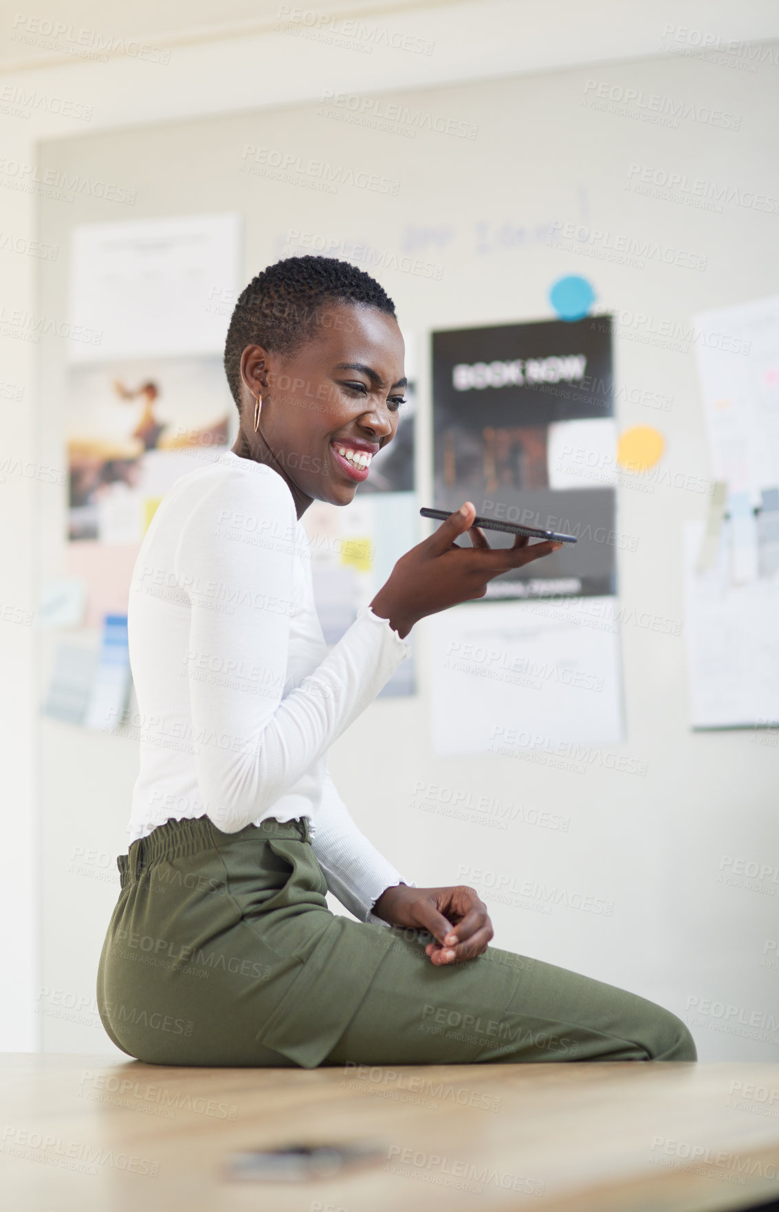 Buy stock photo Shot of a young businesswoman using a cellphone in an office