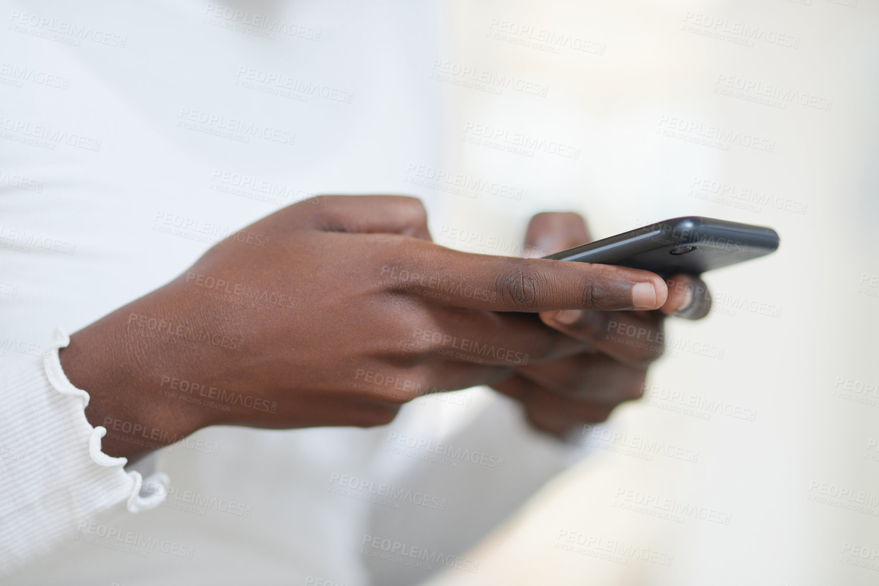 Buy stock photo Closeup shot of an unrecognisable businesswoman using a cellphone in an office