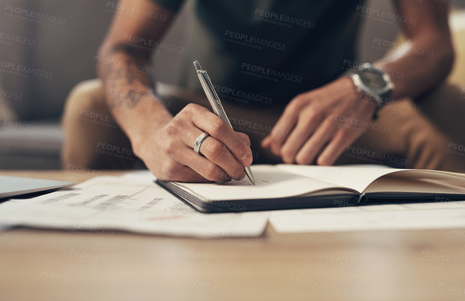 Buy stock photo Cropped shot of an unrecognisable man going over paperwork at home